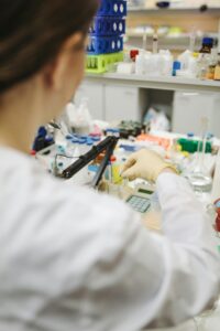 Scientist in a laboratory setting working with test tubes and samples.